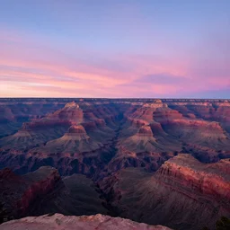 a photograph of a pink and blue sunset at the grand canyon,