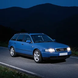 Denim Blue Audi A4 B5 Avant (1997) on a mountain road at night, wide shot