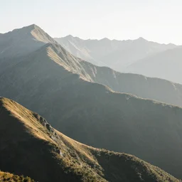 grainy overexposed photograph of mountains in the bright morning light