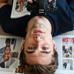 closeup portrait of an australian man watching netflix upside down, natural light, bloom, detailed face, magazine, press, photo, steve mccurry, david lazar, canon, nikon, focus