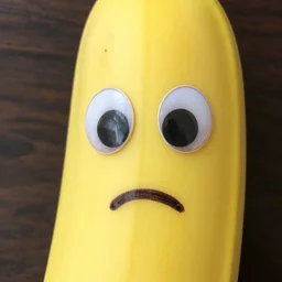 photo of a giant banana with googly eyes and a mouth drawn in with marker