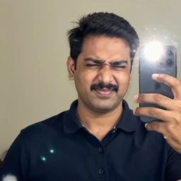 Indian dad taking a selfie squinting because the flash is so bright