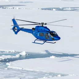 a blue helicopter flying over ice floes