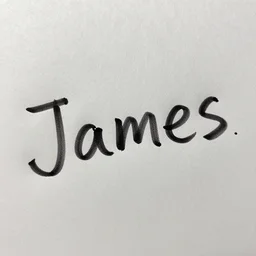 The name James written in ink on a sheet of wet paper