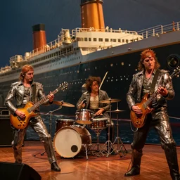 a photo of a metal band playing on titanic while it sinks.