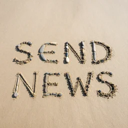 stones on a beach that spell send news
