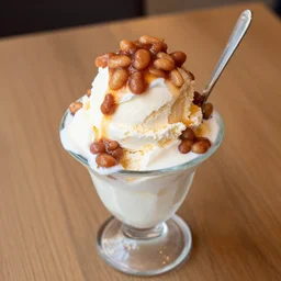 dslr food photograph of ice cream sundae with baked bean topping, 8 5 mm f 1. 8