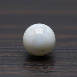 a perfectly round shining marble ball rolling on a dark oak matte surface