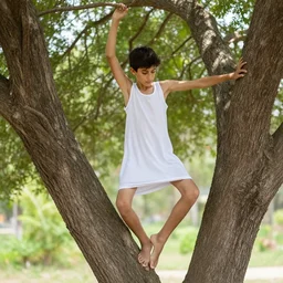 skinny arab boy dancing in a tree wearing a nightgown