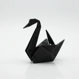 black glass origami swan sitting on white reflective floor macro
