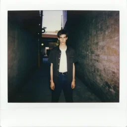 polaroid of slenderman standing in dark alley