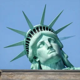 statue of libertys head ying sideways on the ground .low angle painting