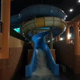 water slide in an indoor water park after hours in the dark, spiral water slide