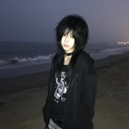 a pale emo goth girl, black hair, on the beach on a foggy night, 2006