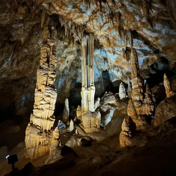 deep inside an ancient cave with stalagmites and stalactites, eerie, photography