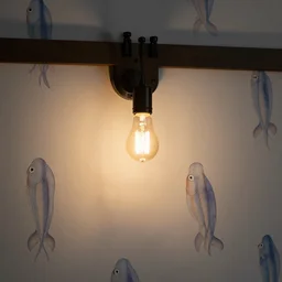 barn pedant lamp with edison lightbulb hanging from wall with blowfish wall paper, low light setting, dim