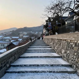 outdoor stairs covered with ice with a cute town below stairs at sunrise