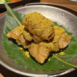 Wow, this food looks so good! It is even served on a leaf and covered with gold!