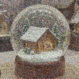 A snowglobe on display with a log cabin inside.