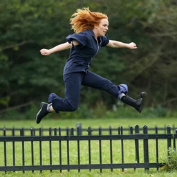 Lindsay Lohan jumping over a small fence