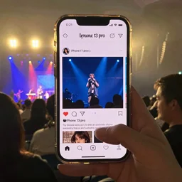 an awkward concert photo, taken on iphone 1 3 pro, instagram, fansite,