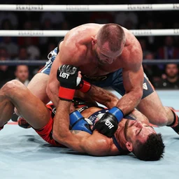 amanda nunes giving a right arm choke to dana white who is losing consciousness