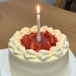 a birthday cake with a bottle of glue replacing the candle