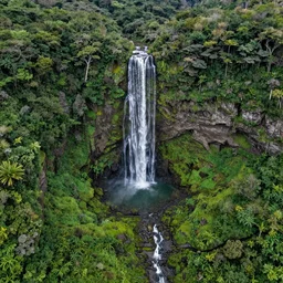 dreamy aerial view of a gorgeous waterfall in a secluded island, highly detailed vibrant valley, drone photography, landscape photography, photorealism, smooth 4k