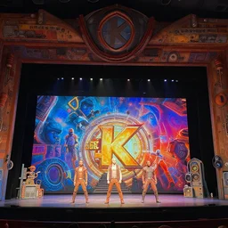 photo of a huge theaterstage, play is guardians of the galaxy, 3 actors on stage, 8 k, multicolored, exaggerated detailed, long shot