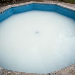 an empty pool filled with white fluid
