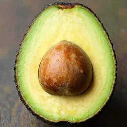 an avocado sliced in half. the middle of the avocado resembles chuck norris