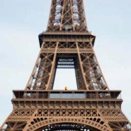close up of a potato stuck on the top of the eiffel tower. photographic, photography