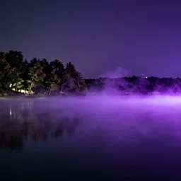 Stunning 4K night photograph of a purple mist rolling over a lake.