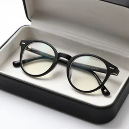 a black colored circular glasses inside a glasses box