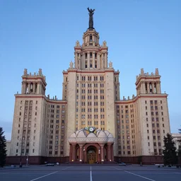 a wide shot of a soviet beautiful brutalist monumental multi - building complex, with many rounded elements sprouting from the base tower creating a feel of an organic structure, photography shot at blue hour
