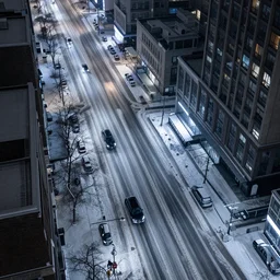a city street at night, snowing, photograph, cyberpunk, sharp focus, intricate detail, drone shot, high resolution, 8k, neon streetlights, wires hanging down everywhere, Japan, colourful, streets filled with cats