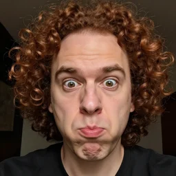a guy with a heavily receding hairline and curly reddish brown hair with multiple chins receding his head into his multiple chins while making a stupid funny meme face selfie