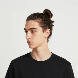 a skinny young white male with a dark brown man bun for hair, no facial hair
