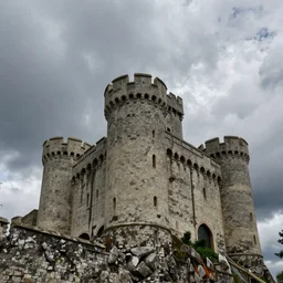 looming castle under a cloudy sky where nary a ray escapes the god's frown