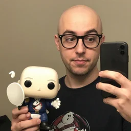 an nerdy balding guy holding a female ghostbuster funko pop, selfie