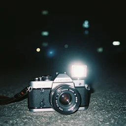 taken using a film camera with 3 5 mm expired film, bright camera flash enabled, brutalist city at night, slightly foggy, creepy, liminal space