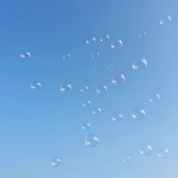 A sky that is full of bubbles of all colors and sizes floating in the sky