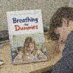 textbook with the cover titled Breathing for Dummies sitting on a desk next to a person who has fallen asleep