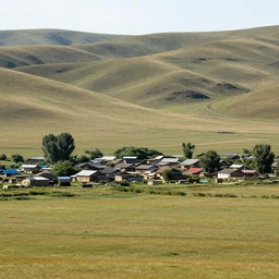 a humble farming village located in a vast landscape of grassy hills