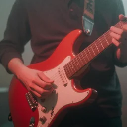 close - up of a hand strumming an electric guitar, red, dreamy, hazy, blurry, ethereal, shoegaze, album art