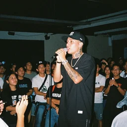 A grime rapper performs to a small crowd in a Filipino nightclub, 35m film