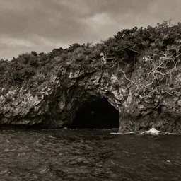 photorealistic sepia painting of a jamaican sea cliff with the mouth of a sea cave, dark, brooding, atmospheric, lovecraft