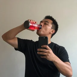 a man taking a selfie of himself drinking a lava lamp