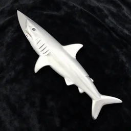 knife shaped like a shark on a black velvet