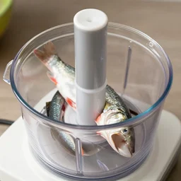 fish being cut in a food processor